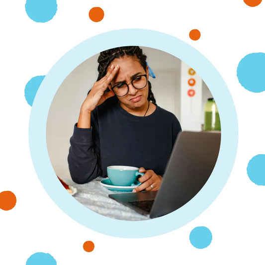 A woman frowns at her computer.