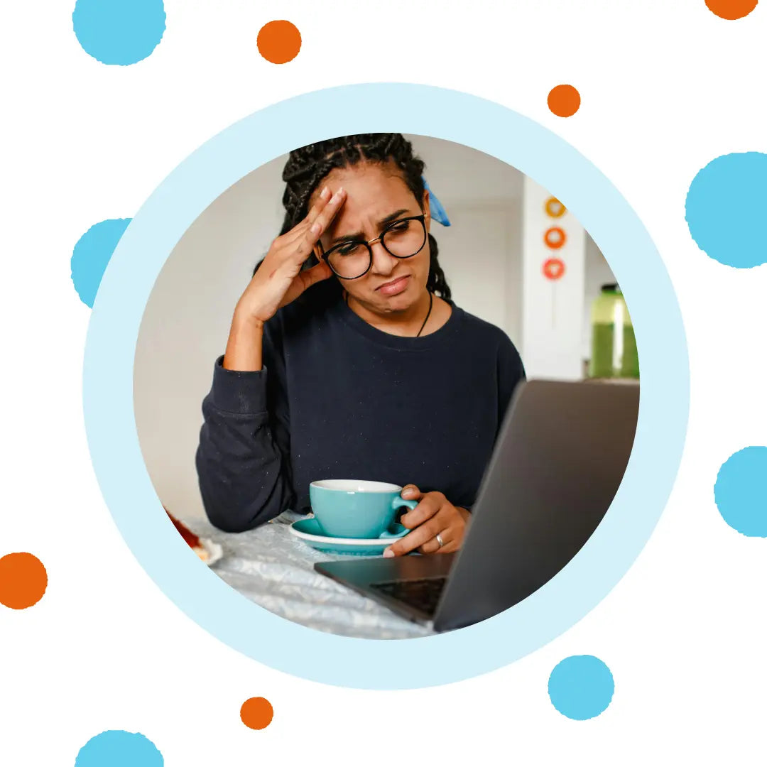 A woman frowns at her computer.