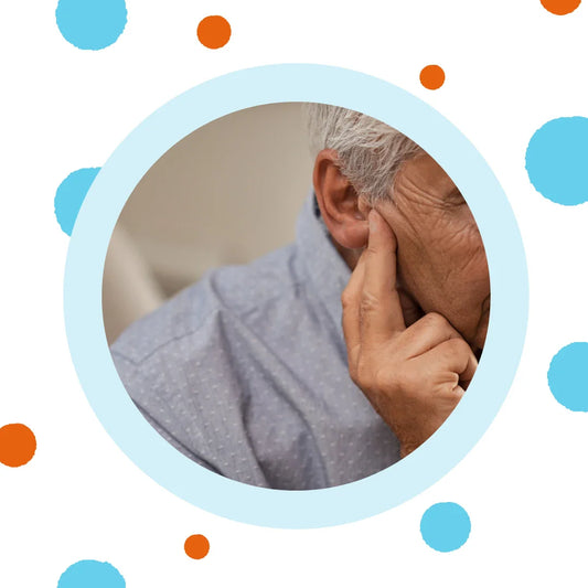 A man presses his hand to his ear.