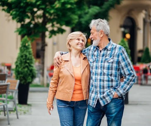 an older couple strolls through the city square