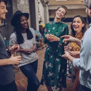 People of varying ages laugh together at a party.