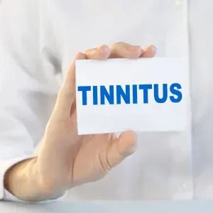 A white-coated person holds a card that says, “Tinnitus.”