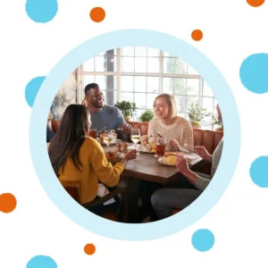 Friends eat at a restaurant. 