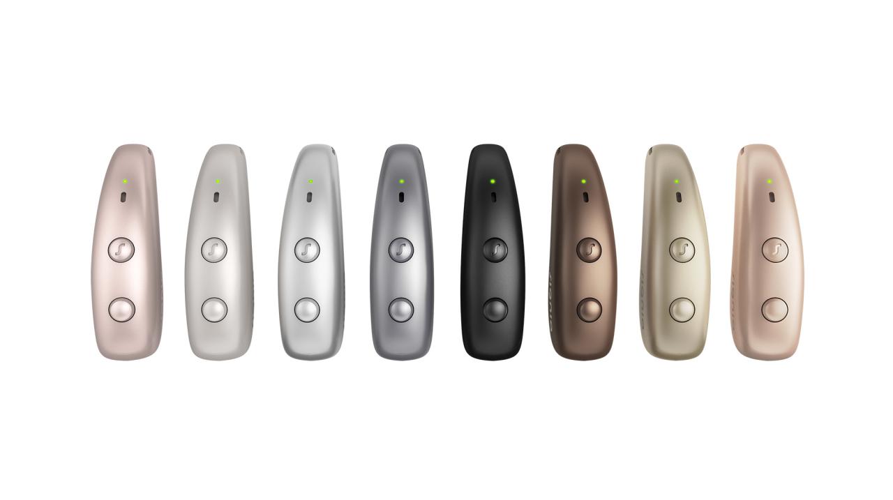 Eight Signia Pure Charge&Go MaX hearing aids in a row, showing every colour in the range.