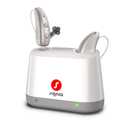 Signia Desktop Charger 2.0 seen from the front, with a pair of Pure Charge&Go MaX hearing aids charging.
