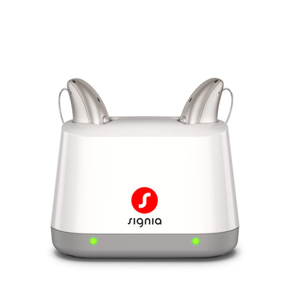 Signia Desktop Charger 2.0 holding a pair of Pure Charge&Go MaX hearing aids while they charge.