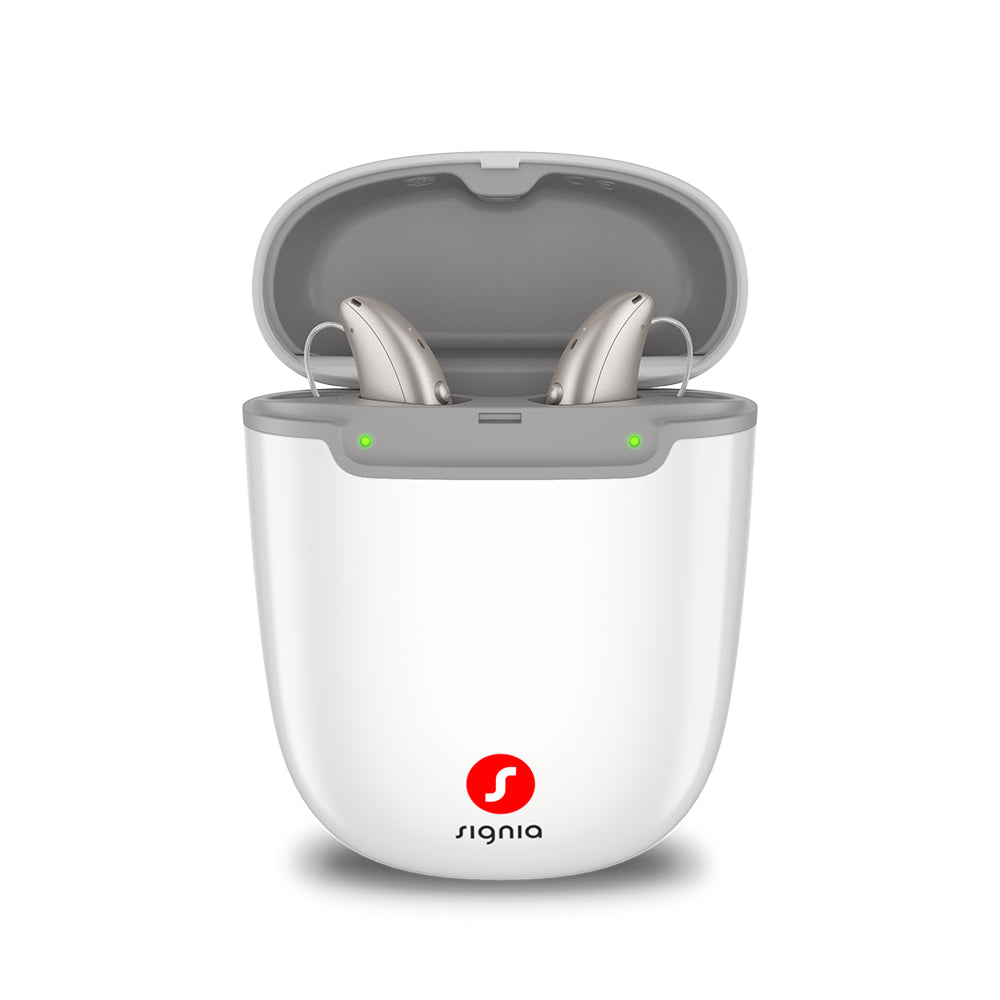 Signia Portable Charger Pure 2.0 holding a pair of Pure Charge&Go MaX hearing aids while they charge.