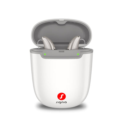 Signia Portable Charger Pure 2.0 holding a pair of Pure Charge&Go MaX hearing aids while they charge.