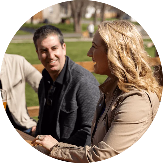 Two people talking and smiling outside