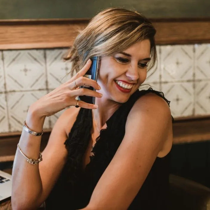 Woman smiling while she is on the phone 