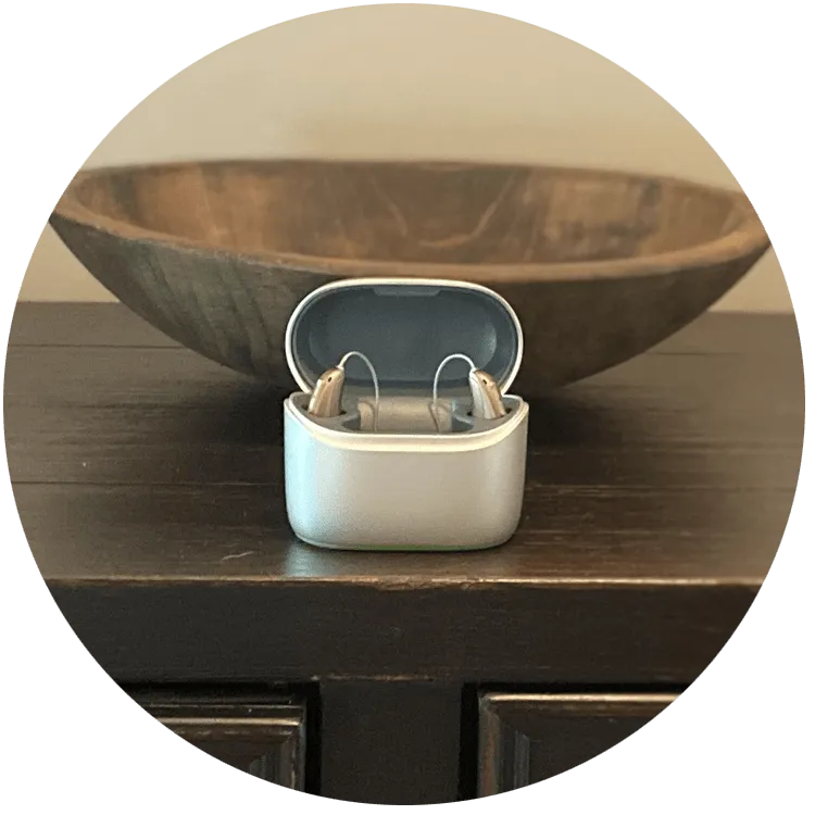 Injoy hearing aids sitting on the table in charger 