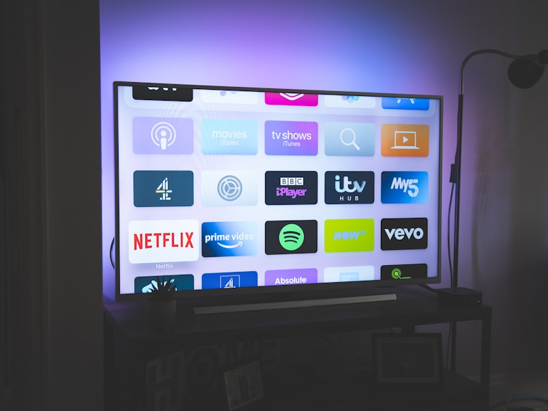 Smart TV displaying various app icons in a dark room