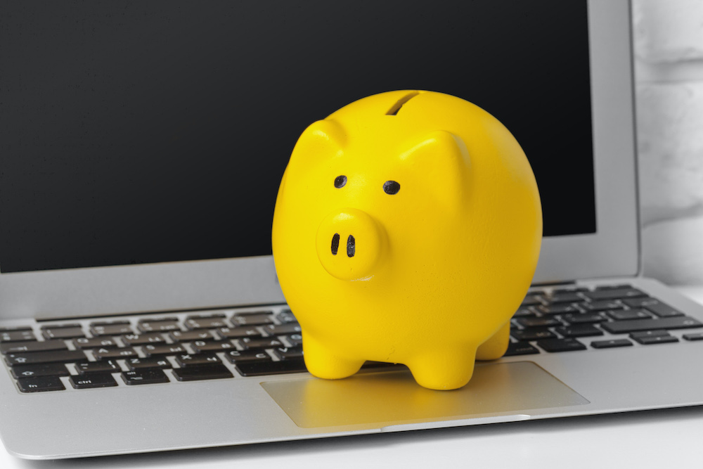 Piggybank on laptop for savings on best hearing aids online at Injoy