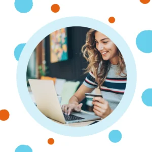 A woman happily shops online. 