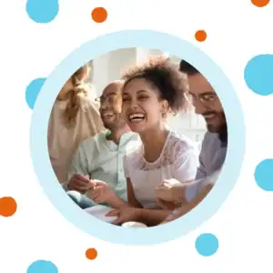 A woman laughs with friends at a restaurant.