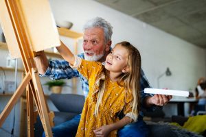 Grandfather spending happy time with granddaughter when he knows where do i get a hearing aid