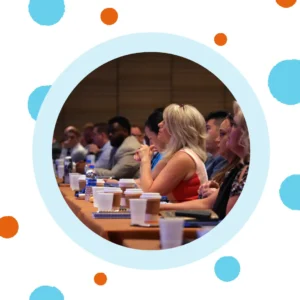 A woman listens at a conference.
