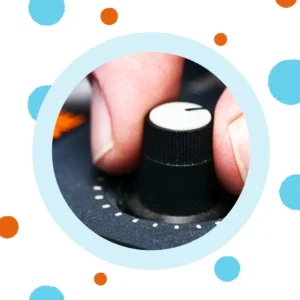 A hand turns a volume dial up. 