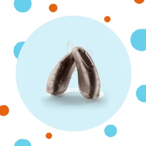 A pair of hearing aids have water droplets on them. 
