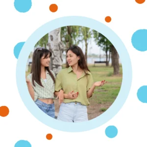 Friends walk and talk outside.