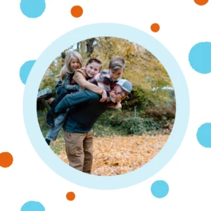 A man carries three kids on his back. 