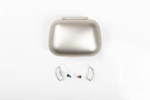 A charging case and two Injoy hearing aids.