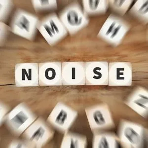 Scrabble letters spell out "noise" in a blurry image.