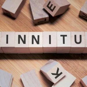 Scrabble letter blocks spell out, "Tinnitus".