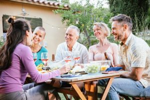 Friends enjoy a dinner party outside.