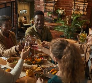 Couples toast during a dinner party.