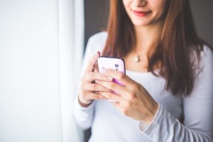 woman holding cell phone