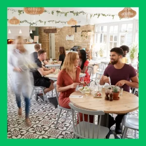 A couple converses in a crowded restaurant.