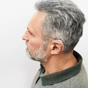 A man wears a hearing aid. 