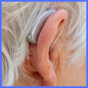 An ear has an open-fit hearing aid. 