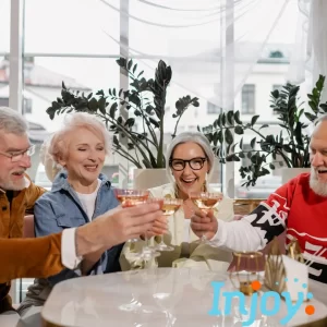 Older friends toast each other at a restaurant. 