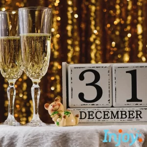 Two champagne glasses stand next to blocks that show December 31st.