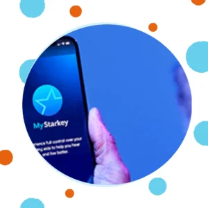 A hand holds a phone with the My Starkey app on it. 