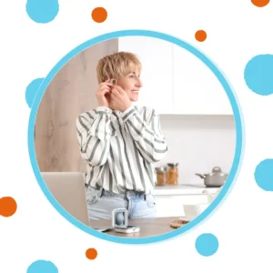 A man puts in his hearing aid. 