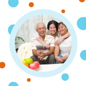 A family smiles together on a couch. 
