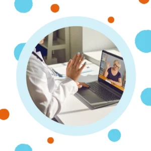 An audiologist waves at a patient. 