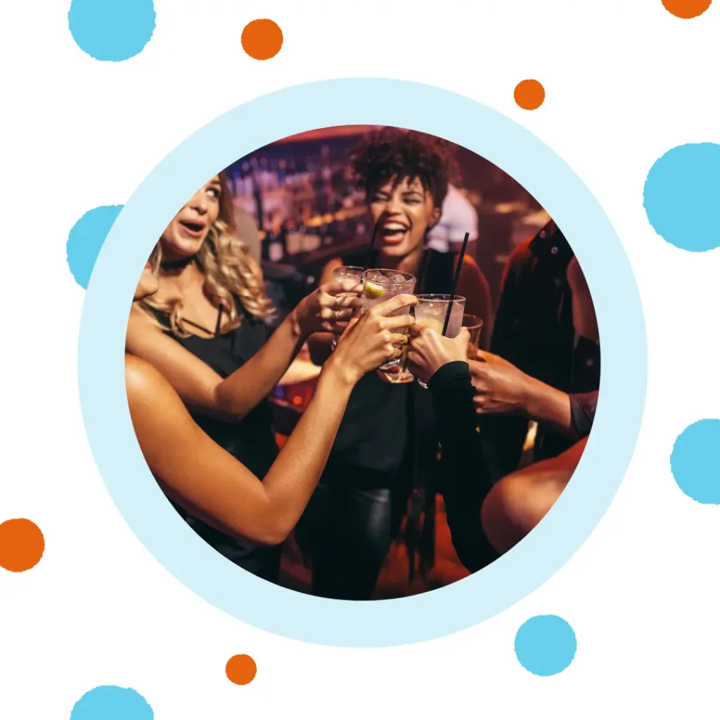 Friends toast together at a bar.