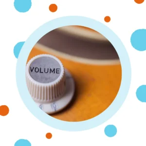 A volume dial sits on an orange background. 
