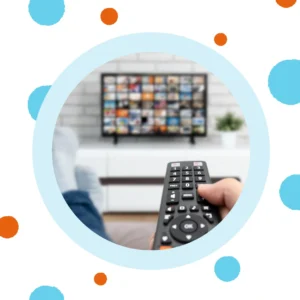 A hand holds a remote and points it at a TV. 