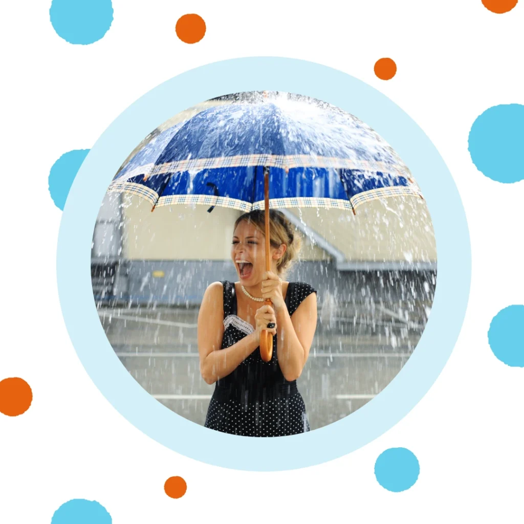 A woman holds an umbrella during a rainstorm.
