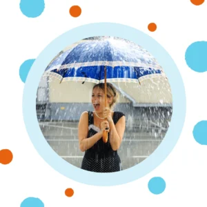A woman holds an umbrella during a rainstorm.
