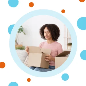 A woman opens a shipping box. 