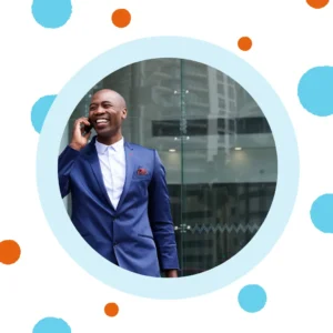 A man in a suit talks on the phone. 