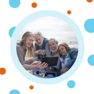 Friends look at a tablet outside.