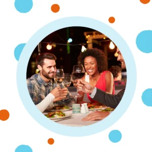 Friends toast each other at a restaurant. 
