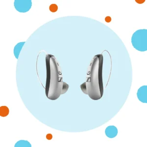 A silver pair of Sennheiser hearing aids sit on a blue background. 